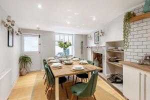a kitchen and dining room with a wooden table and chairs at Divine Georgian Townhouse in the heart of Bath in Bath