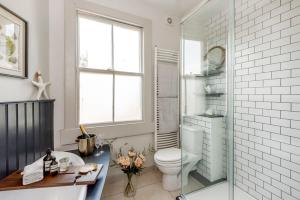 a bathroom with a toilet and a glass shower at Divine Georgian Townhouse in the heart of Bath in Bath