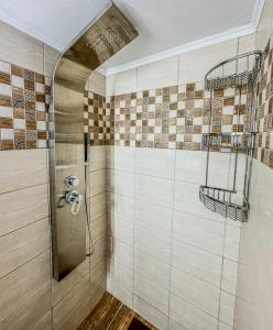 a bathroom with a shower with tiles on the wall at Alyki Salamina House in Salamina +39 photos