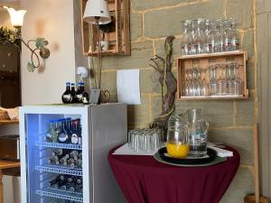 a table with a table cloth next to a refrigerator at Hotel Weinstube am Markt in Gerolzhofen