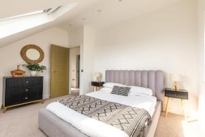 a bedroom with two beds and a staircase at Luxury Home with Garden, Gym, Free Parking & Roof Terrace! in Batheaston