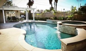 a swimming pool in a yard with a patio at Destination #29 in Anaheim