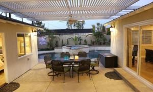 a patio with a table and chairs and a swimming pool at Destination #30 in Anaheim
