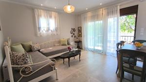 a living room with a couch and a table at Rizes House II in Agios Nikolaos