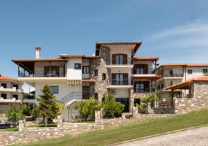an apartment building with a stone wall at Rizes House II in Agios Nikolaos