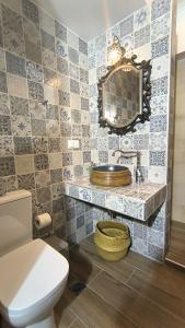 a bathroom with a toilet and a sink and a mirror at Rizes House II in Agios Nikolaos +25 photos