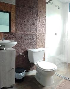 a bathroom with a white toilet and a sink at Hotel Campestre Morichal in Tauramena +20 photos