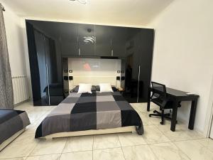 a bedroom with a black bed and a desk at Isola Apartment in Milan