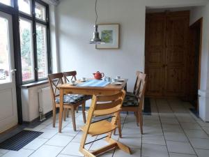 a dining room with a table and chairs in a room at at the organic farm Angus-Hof in Stakendorf