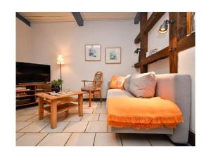 a living room with a couch and a table at at the organic farm Angus-Hof in Stakendorf