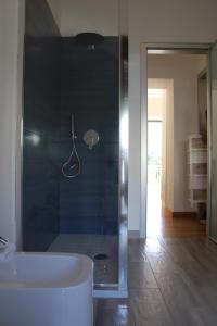 a bathroom with a tub and a glass shower at Atlantide holiday apartments in Castellammare di Stabia