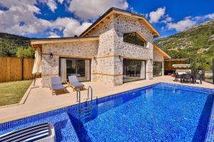 a villa with a pool and a house at Luxury and Cosy villas in Kas