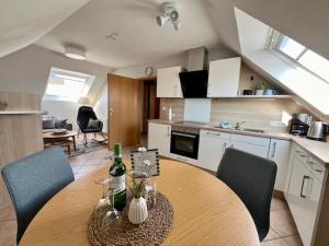 a kitchen with a table and two chairs and a kitchen with a table and chairs at Haus Dollart in Borkum