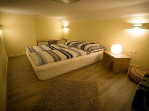 een slaapkamer met een bed en een tafel met een lamp bij Apartment III Björk 