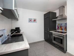 a kitchen with a sink and a stove top oven at Tranquil apartment in Zell-Kaimt in Zell an der Mosel