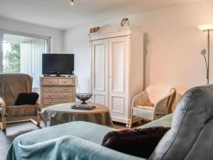 a living room with a couch and a tv at Holiday apartment Owl's Nest in Tennenbronn