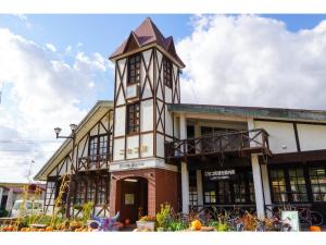 a building with a clock tower on top of it at Hotel Three M - Vacation STAY 93392v in Kutchan