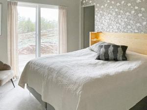 a bedroom with a white bed with a window at 5 star holiday home in VÄSTERVIK-By Traum in Västervik