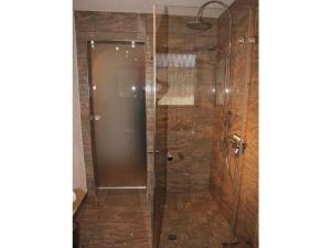 a shower with a glass door in a bathroom at Holiday apartment Schlossblick 2 in Zwingenberg