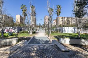 een park in een stad met bomen en gebouwen bij ApartUP Turia River Park in Valencia