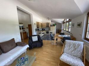 a living room with a couch and chairs and a kitchen at Apartment in Zwingenberg in Zwingenberg