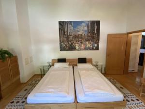 two beds in a room with a painting on the wall at Apartment in Zwingenberg in Zwingenberg
