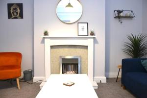 a living room with a fireplace and a mirror at Salisbury - New 3br home, wifi, parking, sleeps 6, near Liverpool city centre in Birkenhead