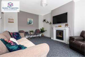 a living room with a couch and a fireplace at Tetuan House - Syster Properties - Work -Family - Groups Leicester LE3 in Leicester
