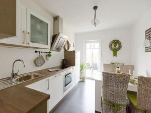 a white kitchen with a sink and a counter top at Holiday apartment Ross in Eslohe