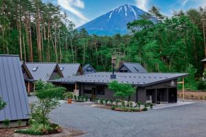 a large building with a mountain in the background at GRAN TOCORO, RESORT&GLAMPING - Vacation STAY 84981v in Narusawa