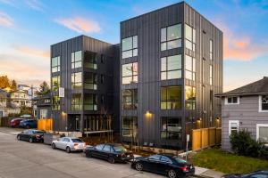 a black building with cars parked in a parking lot at Marion Place in Seattle