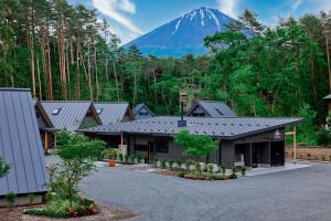 a building with a mountain in the background at GRAN TOCORO, RESORT&GLAMPING - Vacation STAY 84990v in Narusawa
