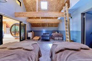 a bedroom with two beds and a loft at GRAN TOCORO, RESORT&GLAMPING - Vacation STAY 84990v in Narusawa
