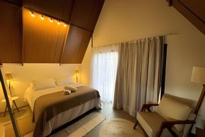 מיטה או מיטות בחדר ב-Cabana Pitomba - Viagem Inspirada