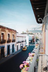 a view from a balcony of a street with cars at Hotel Casa Antigua in Oaxaca City