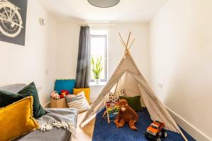 a play room with a teepee tent with a teddy bear at Stunning 5 Bedroom New Build with Amazing Views! in Bath