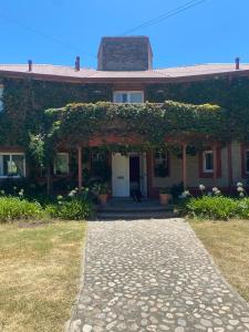 a brick house with an ivy covered doorway at Casa golf en las sierras de Cordoba in Cordoba