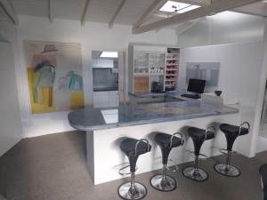 a kitchen with a large counter with stools around it at Künstlerhaus in Überlingen