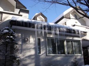 a house with icicles hanging off the side of it at Karuizawa Villa Etoile - Vacation STAY 15095 in Kita-karuizawa