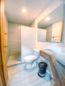 a bathroom with a toilet and a sink at Hotel Sansiraka in Santa Marta