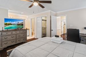 a bedroom with a large bed and a flat screen tv at Time To Relax in Raleigh in Raleigh
