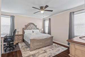 a bedroom with a bed and a desk and a ceiling fan at Time To Relax in Raleigh in Raleigh
