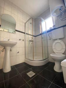 un bagno con doccia, WC e lavandino di Starlight Apartments a Ulcinj Altre 43 foto