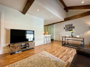 a living room with a large flat screen tv at The Bell Tower in Inverness