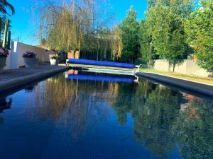 una piscina de agua con bancos y árboles azules en Villas del Bosque, en El Pueblito