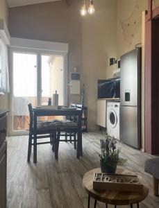 a living room with a table and a kitchen at Appartement Saint Pierre la mer vue Mer in Fleury +7 photos