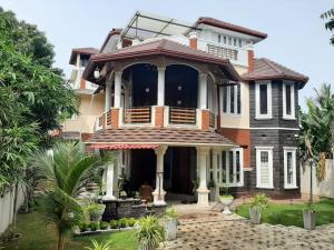 a large house with a balcony on top of it at Royal Feather Jaffna in Tirunelveli East