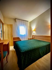 Postel nebo postele na pokoji v ubytování Hotel Ponte Molo