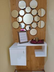 a wall with a bunch of circular mirrors at Sunset Apartment in Praia