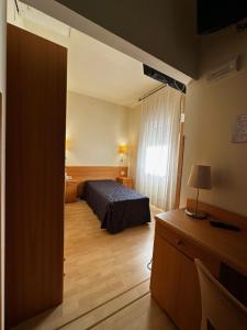 Postel nebo postele na pokoji v ubytování Hotel Ponte Molo
